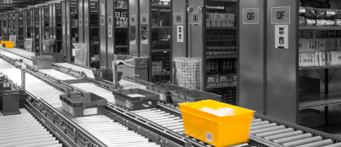 Golden tote in colour with black and white background of warehouse